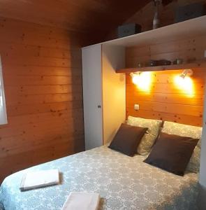 a bedroom with a large bed with a wooden headboard at Chalet Beau Rivage in Gunsbach