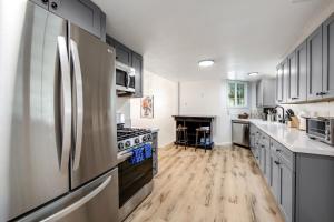 a kitchen with stainless steel appliances and wooden floors at Red Cottage Charmer in Lake Arrowhead
