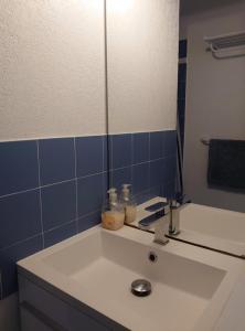 a bathroom with a white sink and a mirror at 4RB4 Appartement type T2 bord de mer ACCES PLAGE DIRECT in Collioure