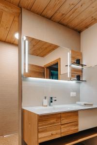 a bathroom with a sink and a mirror at Planai Apartment mit Dachstein Blick in Schladming