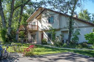 a house with a balcony and a yard at Willard Lake House in Bass Lake