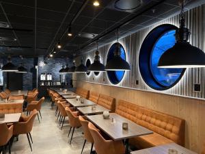 a row of tables and chairs in a restaurant at Arctic Sea Hotel in Hammerfest