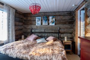 a bedroom with a bed and a wooden wall at A room (or 2 or 3) in a Lapland House of Dreams in Rovaniemi