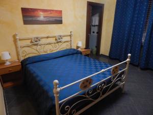 a bedroom with a bed with a blue comforter at albergo massimo in Loano