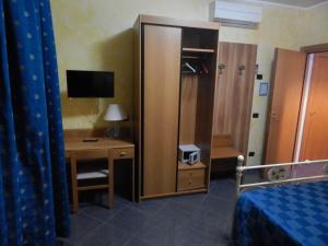 a hotel room with a desk and a bed and a computer at albergo massimo in Loano