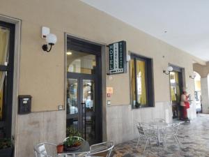 a restaurant with tables and chairs outside of a building at albergo massimo in Loano