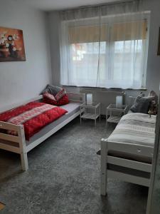 a bedroom with two beds and a window at Haus Sorgenfrei in Caputh