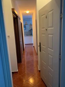 a hallway with two doors and a tile floor at Apartment with swimmingpool, seaview and large terrace, 1st floor, min 2 persons in Dobrota