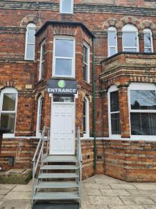 an entrance to a brick building with a white door at Park View in Hull