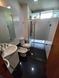a bathroom with two toilets and a shower at Parana Riverside Guest House - Posadas in Posadas