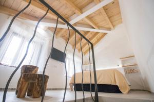 a bedroom with a bed and a wooden ceiling at El Pequeño Pajar in Majaelrayo