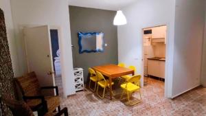 a room with a table and chairs and a kitchen at Cathedral Malaga Hostel in Málaga