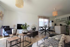 a living room with a couch and a table at Les Bastidons de l'Isle - Le Seguret - 3 étoiles in LʼIsle-sur-la-Sorgue