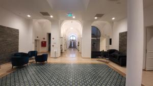 a hallway with a living room with a couch and chairs at D50 Hotel in Budapest