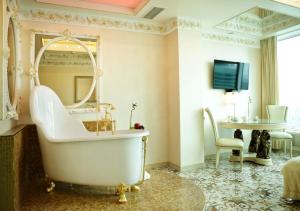 a bathroom with a tub and a mirror and a table at Imperia City in Moscow