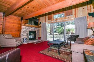a living room with a stone fireplace in a house at Switzerland Ski Chalet-845 by Big Bear Vacations in Big Bear Lake