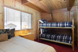 a bedroom with two bunk beds in a cabin at Switzerland Ski Chalet-845 by Big Bear Vacations in Big Bear Lake