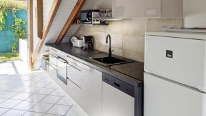 a kitchen with a sink and a counter top at Chez Claire & Eric in Terre-de-Haut