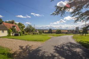 an empty road in a residential neighborhood with houses at The Annexe in Hawkedon