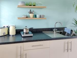 a kitchen with a sink and a counter top at The Annexe in Hawkedon