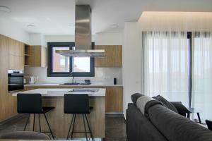 una cocina con sofá y una isla de cocina con sillas en Phaedrus Living: City View Anna Residence 101, en Limassol