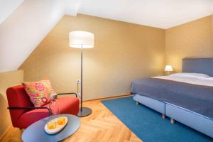 A bed or beds in a room at Alma Hotel