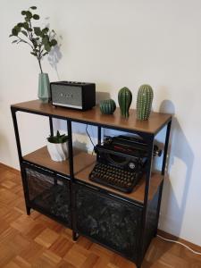 a table with a keyboard and plants on it at ZEN Apartments - Exklusive Suite - Luxus - Boxspringbett in Karlsruhe
