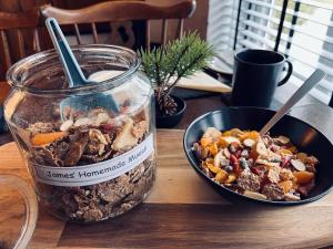 a jar of food next to a bowl of food at The Lake View Hotel in Llanberis