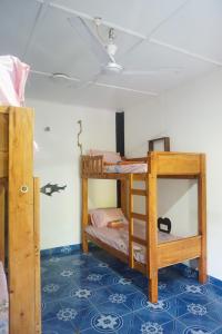 a room with two bunk beds and a ceiling at Akki's Hostel in Trincomalee