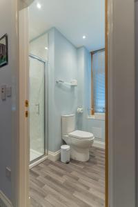 a bathroom with a toilet and a glass shower at Galvelbeg House self catering apartment in Crieff