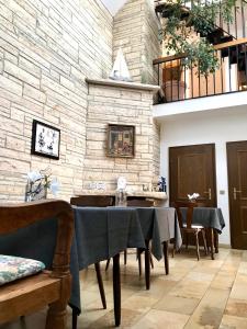 a dining room with a table and a stone wall at Haus Witten Höhen Ferienwohnungen in Cuxhaven