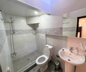 a bathroom with a toilet and a sink at Griboedov Apartment in Tbilisi City