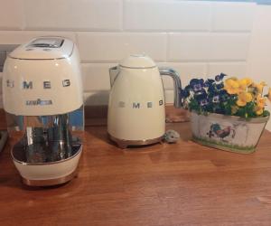 a kitchen counter with a blender and a vase of flowers at Casale Monte Valestra in Bebbio