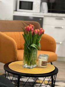 a vase of pink tulips sitting on a table at Apartments Noa Old Town in Dubrovnik