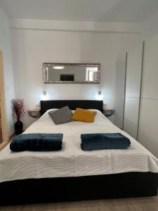 a bedroom with a large bed with two pillows on it at Apartments Noa Old Town in Dubrovnik