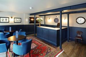 a bar with blue chairs and tables in a restaurant at The Merchant's House, BW Signature Collection in Salisbury