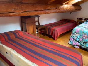 Un pat sau paturi într-o cameră la Casa Ornella - Baita Pra Sec