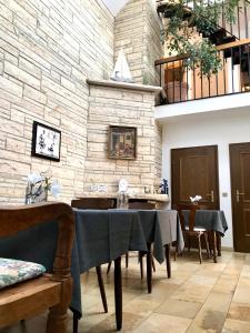 a dining room with a table and a stone wall at Haus Witten Höhen in Cuxhaven