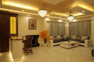 a living room with a couch and a table at The Cerro Rico - 3-Bedroom Modern Villa in Kasauli