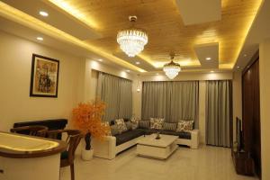 a living room with a couch and a table at The Cerro Rico - 3 BHK Modern Villa in Kasauli
