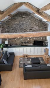 a living room with a couch and a stone wall at Moss Tarn in Ulverston