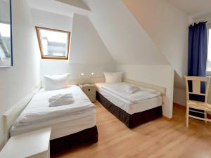 Postel nebo postele na pokoji v ubytování Villa Strandidyll - WG13 mit Meerblick