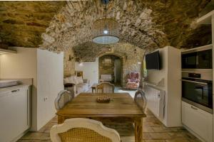 a kitchen and dining room with a wooden table and chairs at Apartamento en el centro in Begur