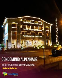 a building with lights on it at night at Alpenhaus Gramado Flat Temporada in Gramado