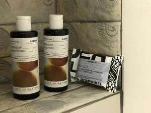two bottles of essential oils sitting on a shelf at Studio Cozy - In the Heart of Skyros Village in Skiros