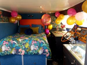 a bedroom with balloons and a bed in a van at JASMINE CORAL JAY Boutique Boatel Ocean Village in Gibraltar +85 photos