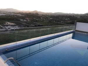 a swimming pool on the roof of a building at Suite Vitbanus in Marbella