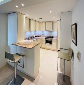 a kitchen with white cabinets and a counter top at Residence Carlton Riviera in Cannes