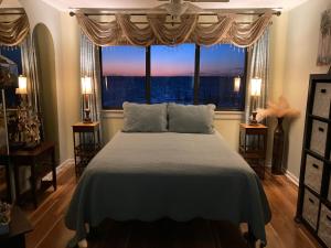 a bedroom with a large bed and a window at Romantic condo for 2-Sunset Harbor Palms 1-205, pool, fishing pier in Navarre +49 photos