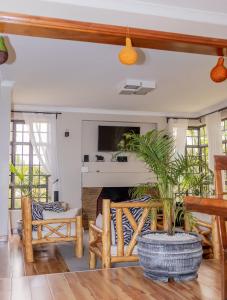 a living room with a couch and a fireplace at Enkarsis Resort Villa in Kitengela 